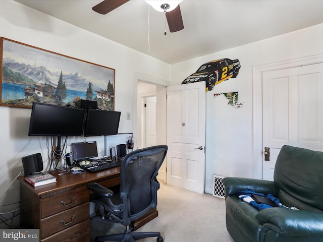 carpeted office space with ceiling fan