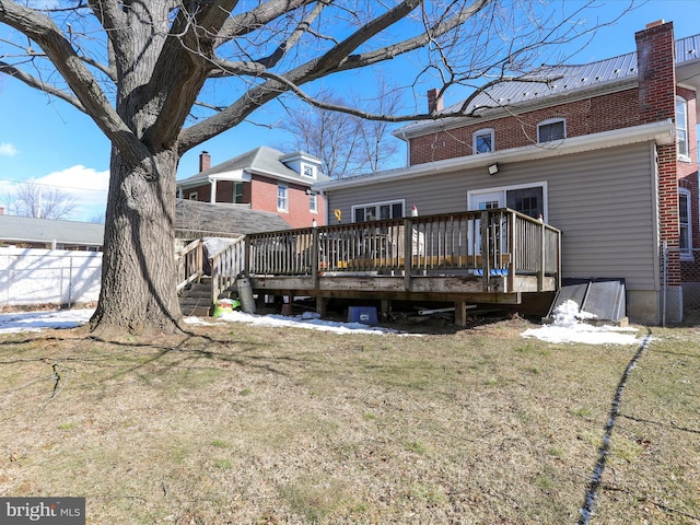 rear view of property with a yard and a wooden deck