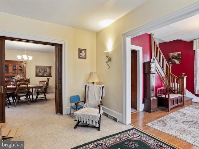 sitting room with a chandelier and light colored carpet