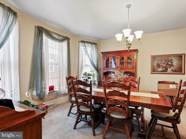 dining area with a notable chandelier and carpet flooring