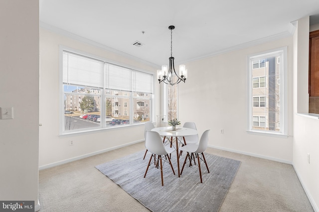 dining space featuring crown molding, light colored carpet, visible vents, a chandelier, and baseboards