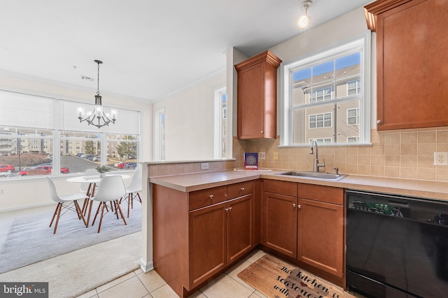 kitchen with a sink, tasteful backsplash, dishwasher, and light tile patterned flooring