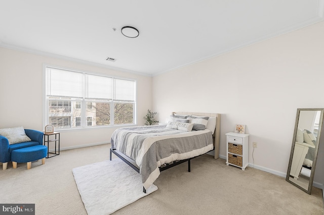 carpeted bedroom with baseboards, visible vents, and crown molding