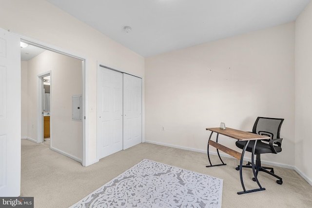 home office with carpet floors, electric panel, and baseboards