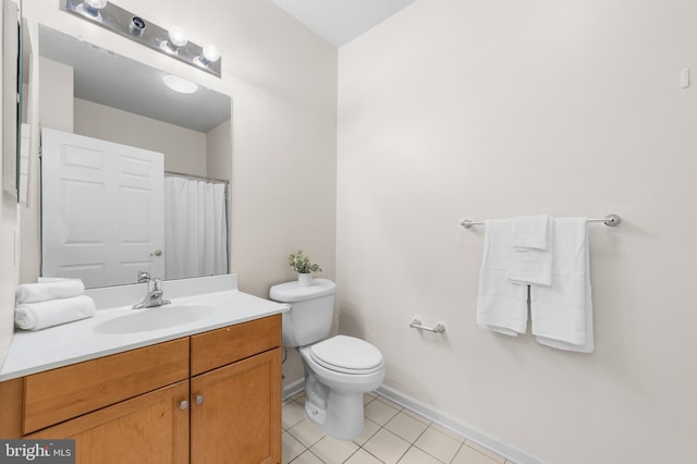 full bath featuring baseboards, vanity, toilet, and tile patterned floors