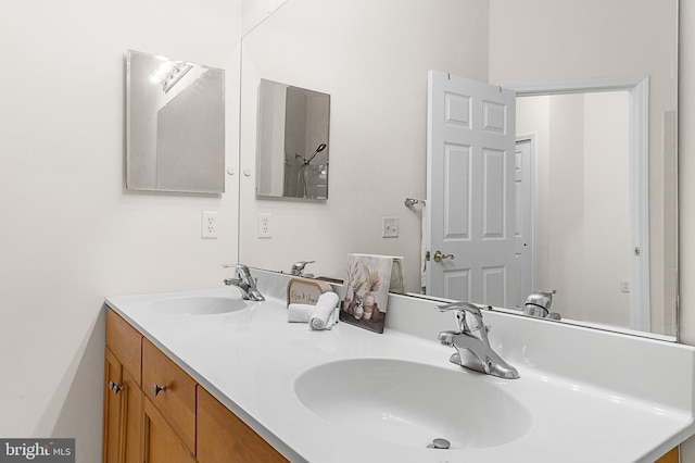 full bathroom with double vanity and a sink