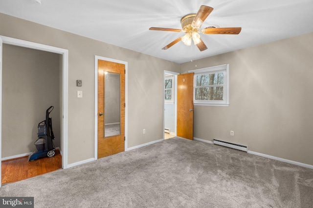 unfurnished bedroom with carpet floors, a baseboard radiator, baseboards, and ceiling fan