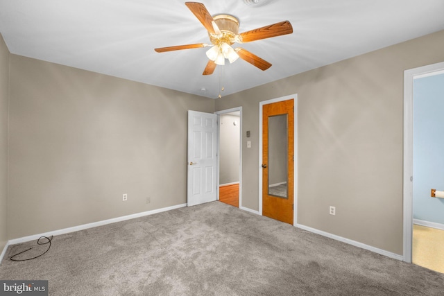 unfurnished bedroom with carpet floors, a ceiling fan, and baseboards