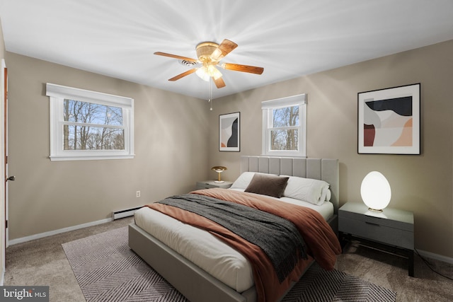 bedroom with a baseboard heating unit, baseboards, a ceiling fan, and light colored carpet