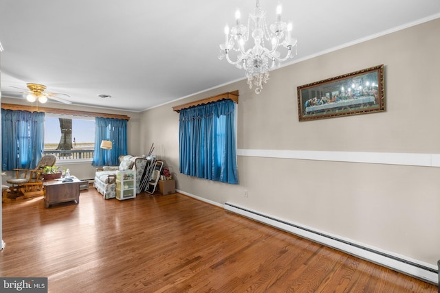 sitting room with a baseboard radiator, crown molding, wood finished floors, and ceiling fan with notable chandelier