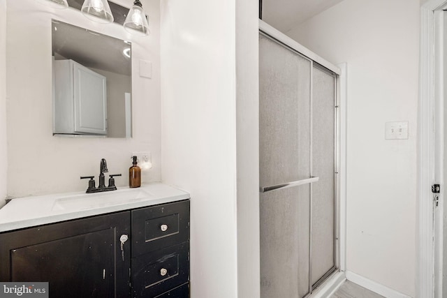 bathroom featuring a stall shower and vanity