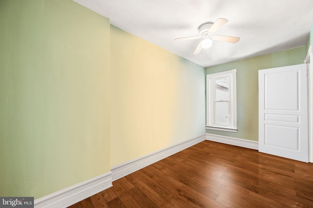 unfurnished room featuring a ceiling fan, baseboards, and wood finished floors