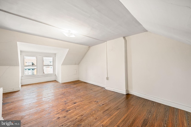 additional living space featuring lofted ceiling, wood finished floors, and baseboards