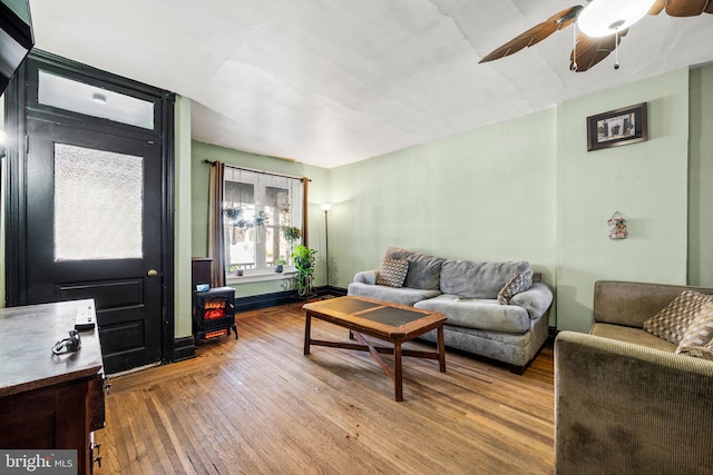 living area with a ceiling fan and light wood-style flooring