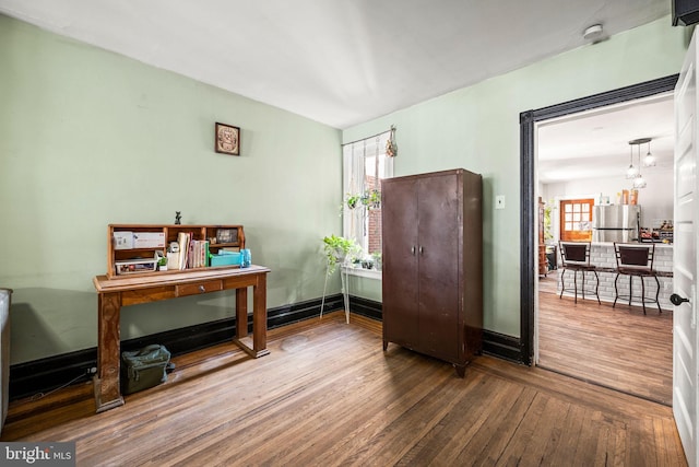 office featuring baseboards and wood finished floors