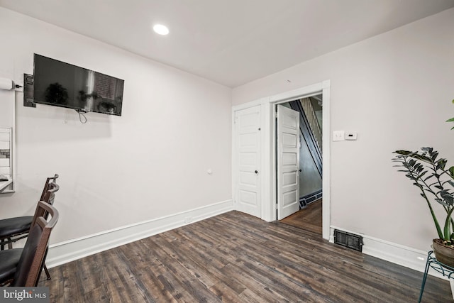 office space with dark wood-type flooring, recessed lighting, visible vents, and baseboards