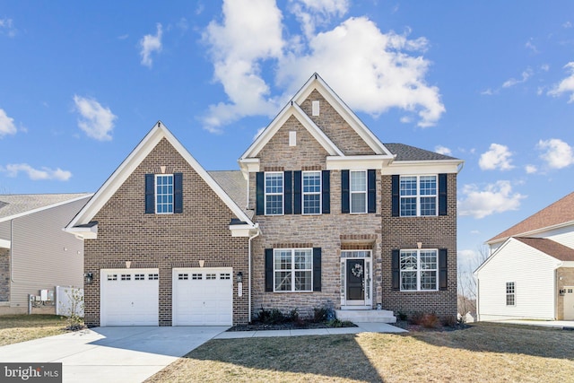 view of front facade with a garage, a front lawn, concrete driveway, and brick siding