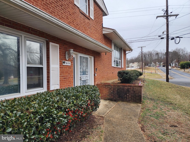 doorway to property featuring a yard