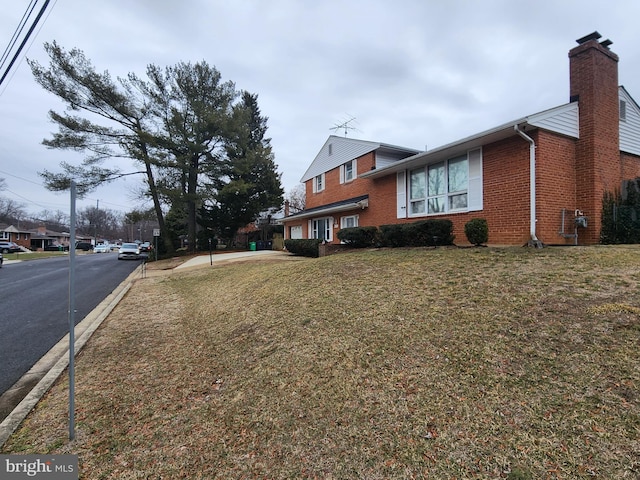 view of side of property with a lawn