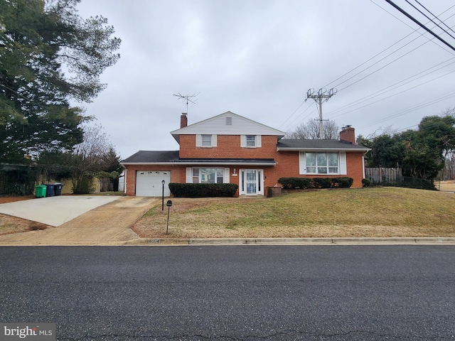 view of front of property featuring a front yard and a garage