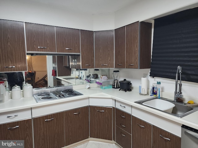 kitchen with sink, stainless steel appliances, and dark brown cabinetry