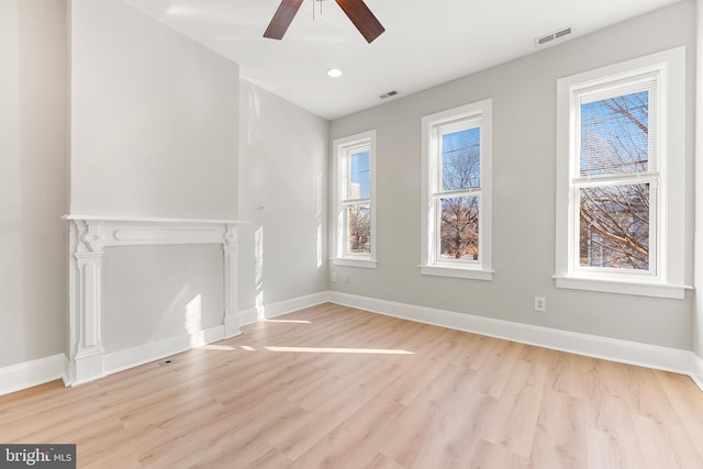 unfurnished living room with ceiling fan and light hardwood / wood-style floors