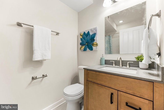 bathroom with vanity and toilet