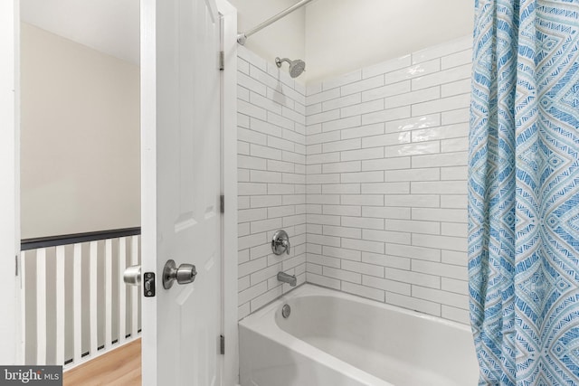 bathroom featuring hardwood / wood-style flooring and shower / tub combo