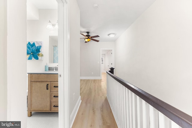 hall with sink and light hardwood / wood-style floors