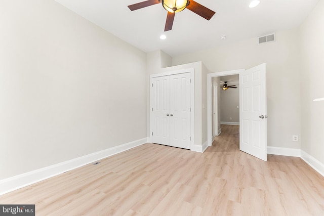 unfurnished bedroom featuring light hardwood / wood-style flooring, a closet, and ceiling fan