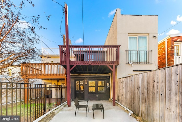 rear view of house with a patio area and a balcony