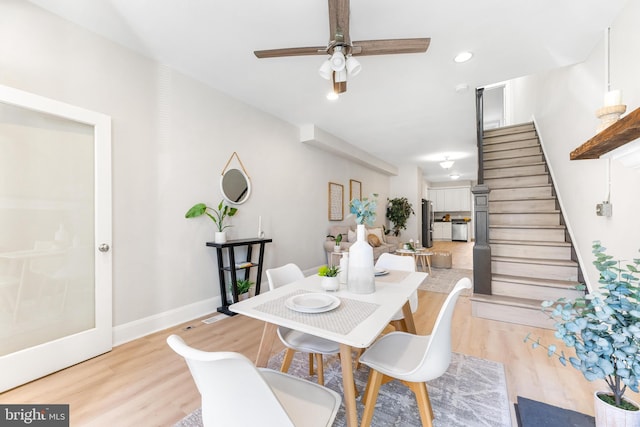 dining area with ceiling fan and light wood-type flooring