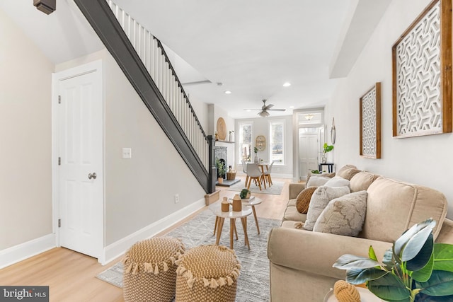 living room with ceiling fan and light hardwood / wood-style floors