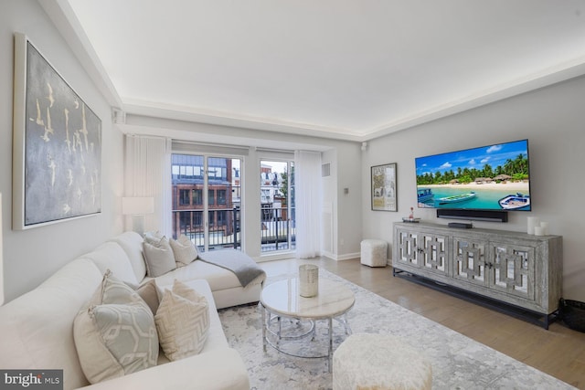 living area featuring light wood finished floors and baseboards