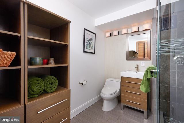 bathroom featuring walk in shower, vanity, and toilet