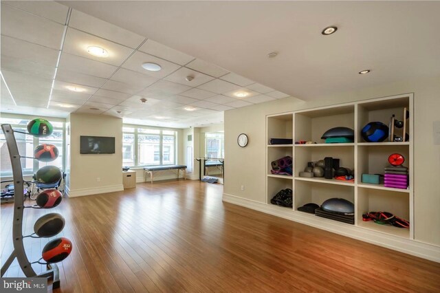 130 S 18th St Unit 3103, Philadelphia, PA 19103 - workout area featuring a paneled ceiling, hardwood / wood-style floors, and built in shelves