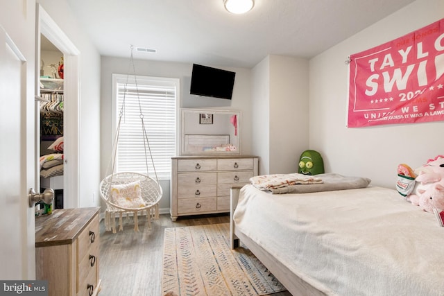 bedroom with hardwood / wood-style flooring