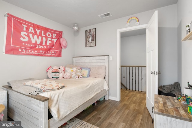 bedroom with dark wood-type flooring