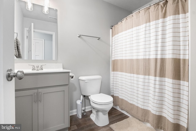 bathroom featuring vanity, hardwood / wood-style flooring, and toilet