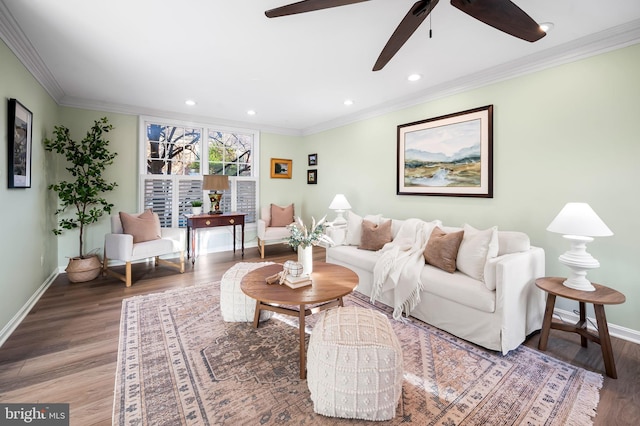 living area with ornamental molding, recessed lighting, wood finished floors, and baseboards