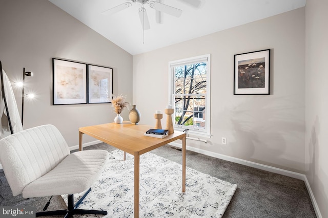 carpeted office with a ceiling fan, vaulted ceiling, and baseboards