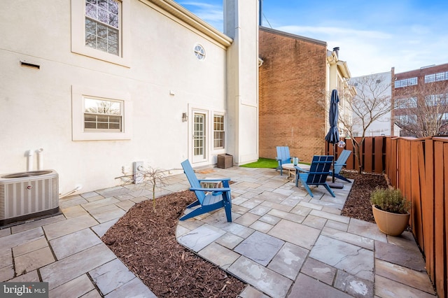 view of patio / terrace featuring a fenced backyard and central AC