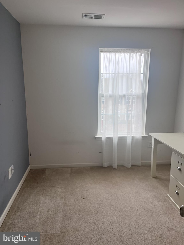 unfurnished room featuring light colored carpet