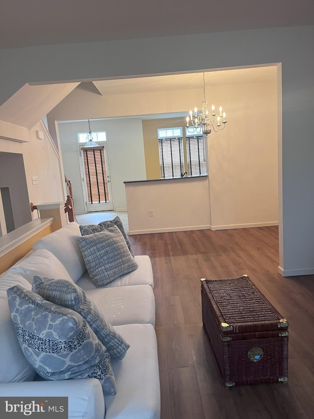 living room with a notable chandelier and dark hardwood / wood-style flooring