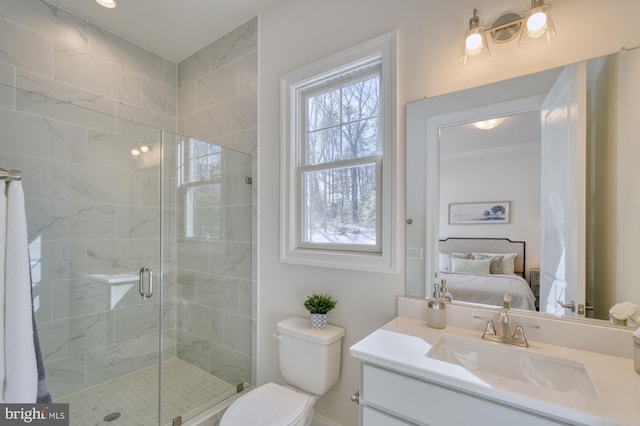 ensuite bathroom with vanity, a shower stall, toilet, and ensuite bathroom