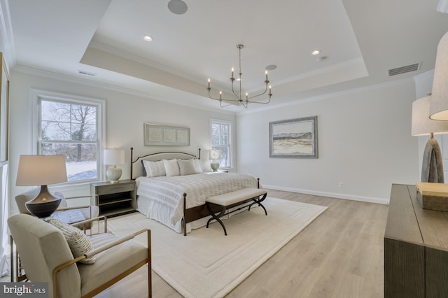 bedroom with visible vents, multiple windows, and a tray ceiling