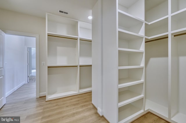 walk in closet featuring light wood finished floors and visible vents