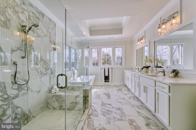 bathroom featuring a marble finish shower, a raised ceiling, a soaking tub, ornamental molding, and a sink