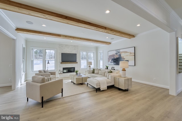 living area featuring ornamental molding, beam ceiling, and a stone fireplace