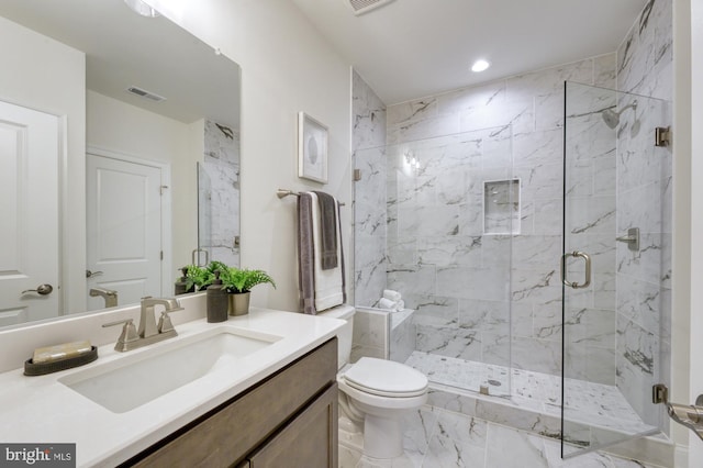 bathroom featuring a marble finish shower, visible vents, toilet, marble finish floor, and vanity